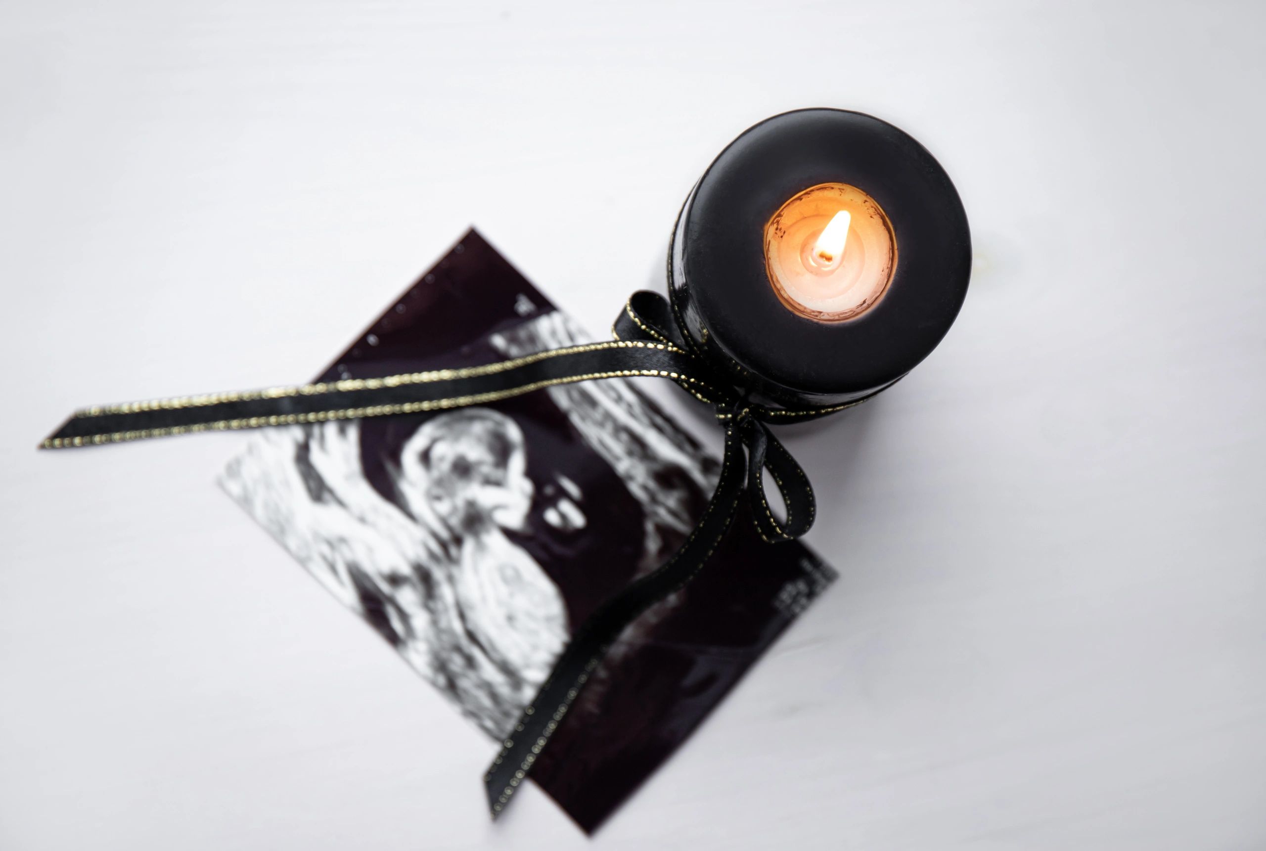 Candle with ribbon symbolizing remembrance