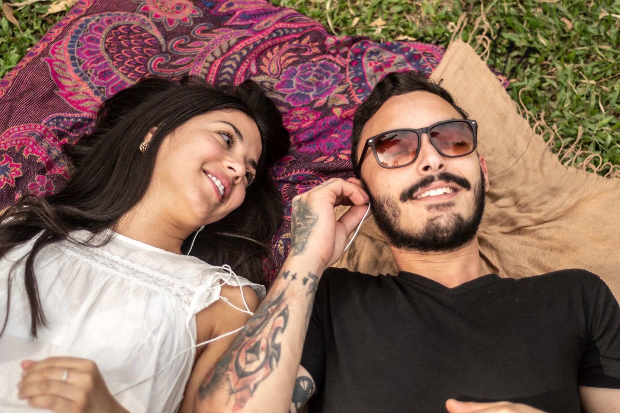 Couple listening to music together outdoors