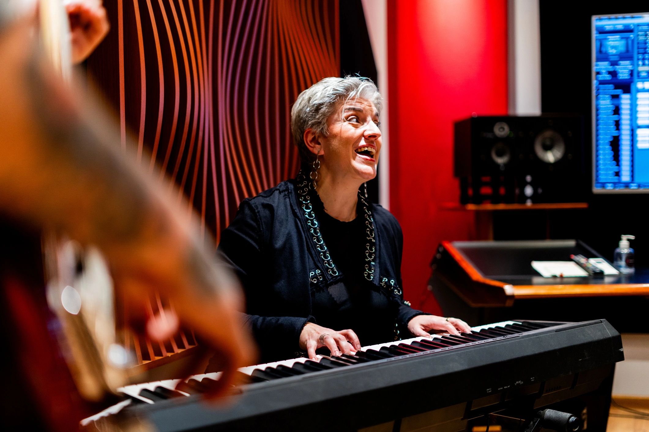 Person playing piano in a music studio